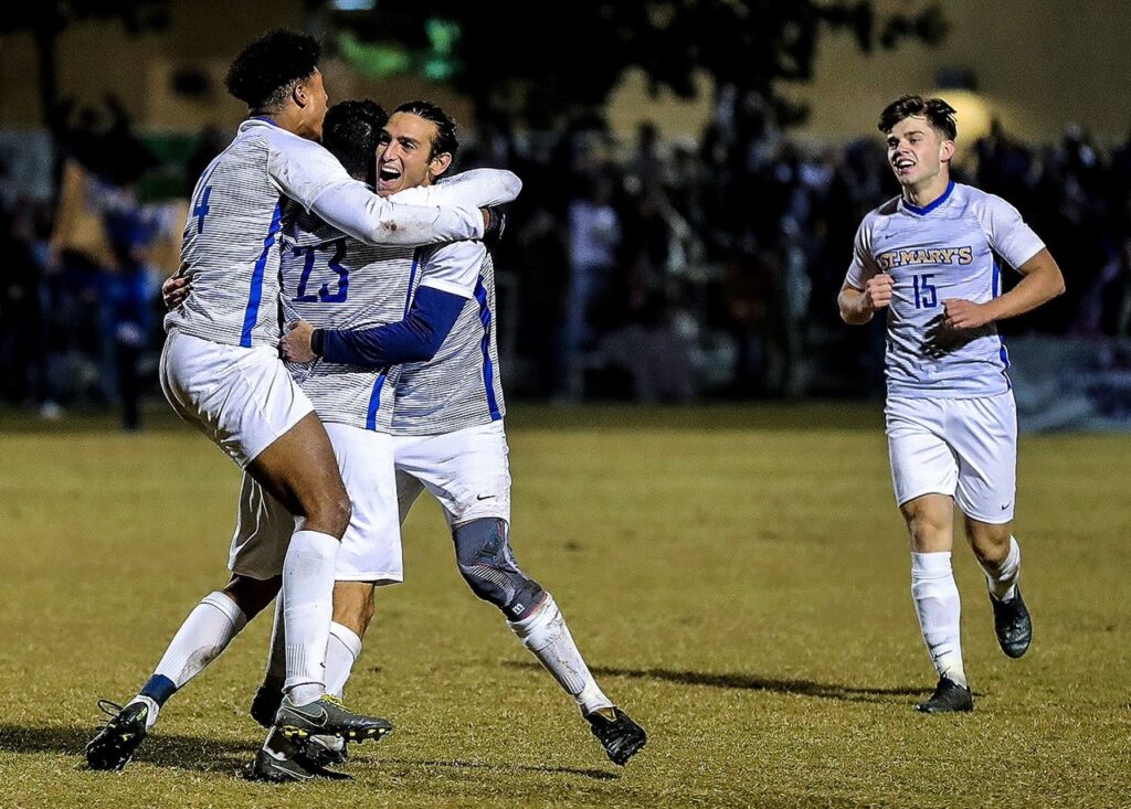 St. Mary's University men's soccer team celebrating on the field